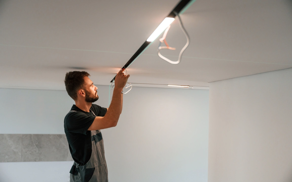 Electrician installing light