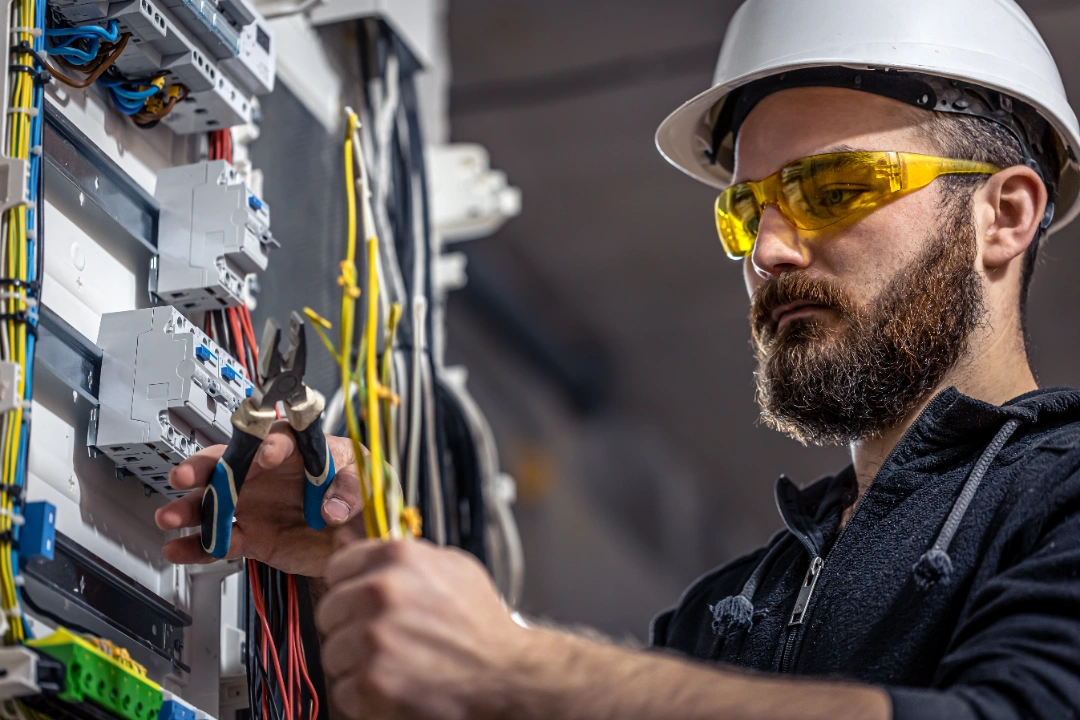 Electrician working on switchboard